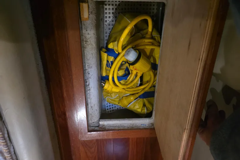 Slide: The Image of Storage compartment on 2002 Sea Ray 560 Sedan Bridge with yellow power cables. - 96