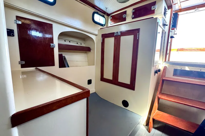 Slide: The Image of Interior of 1976 Downeast Flybridge Cruiser with wooden cabinetry and stairs. - 33