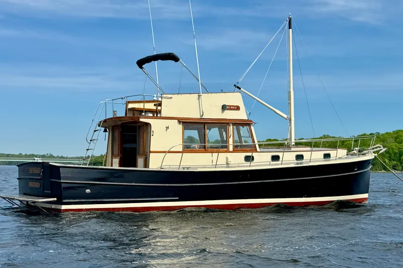 Slide: The Image of 1976 Downeast Flybridge Cruiser on water, showcasing classic design and elegant craftsmanship. - 4