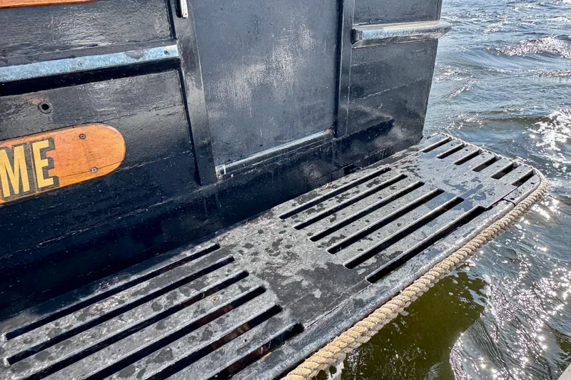 Slide: The Image of 1976 Downeast Flybridge Cruiser stern platform on water, showcasing vintage nautical design. - 55