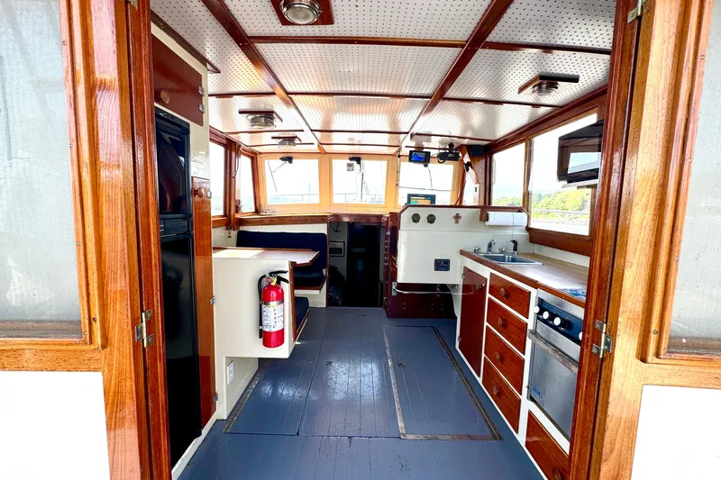 Slide: The Image of Interior of a 1976 Downeast Flybridge Cruiser with wooden cabinetry and nautical equipment. - 6
