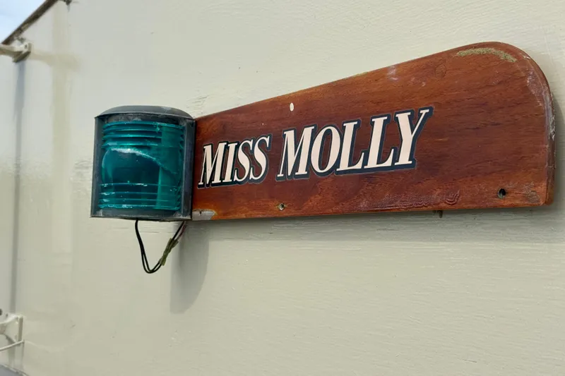 Slide: The Image of Wooden nameplate "Miss Molly" on 1976 Downeast Flybridge Cruiser with green navigation light. - 65