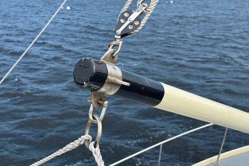 Slide: The Image of Close-up of rigging on a 1976 Downeast Flybridge Cruiser over water. - 66