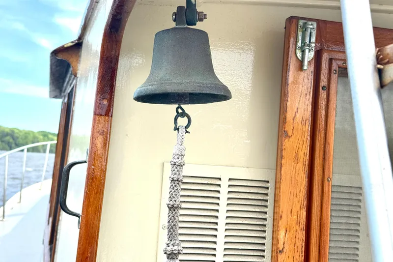 Slide: The Image of Vintage 1976 Downeast Flybridge Cruiser with nautical bell and wooden details. - 68