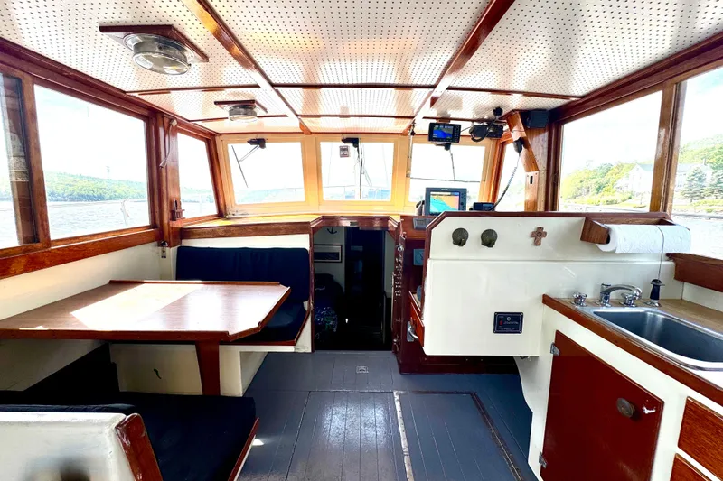 Slide: The Image of Interior of a 1976 Downeast Flybridge Cruiser with wood accents and nautical equipment. - 7