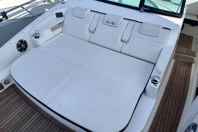 Slide: The Image of Luxurious seating on 2020 Sea Ray Sundancer 320 Coupe with white upholstery and wooden deck. - 17