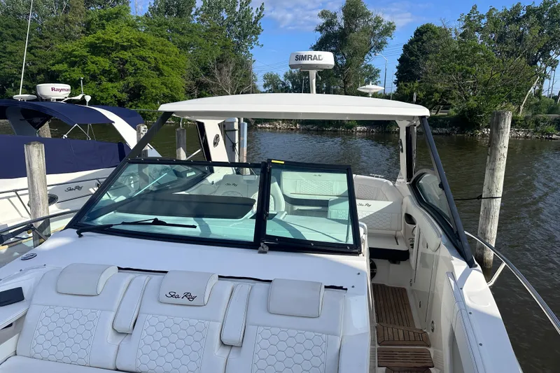 Slide: The Image of 2020 Sea Ray Sundancer 320 Coupe docked, featuring sleek design and luxurious seating. - 18