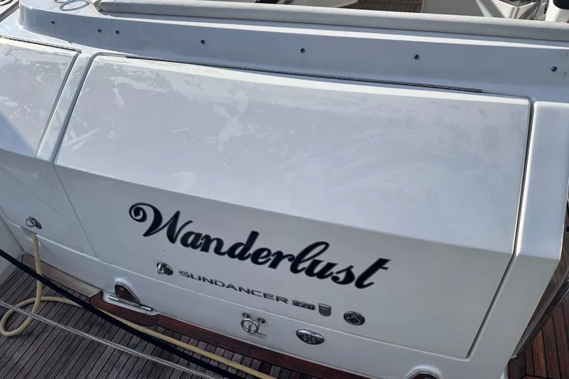 Slide: The Image of 2020 Sea Ray Sundancer 320 Coupe boat with "Wanderlust" name on the stern. - 19