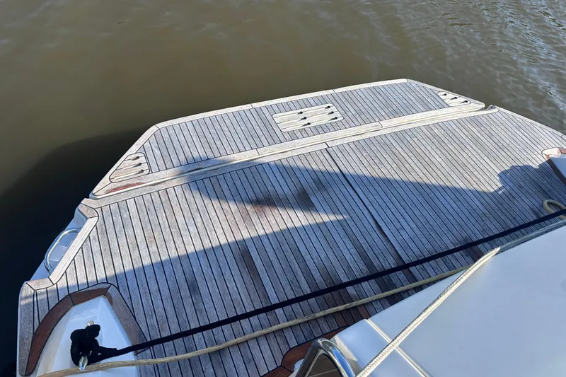 Slide: The Image of 2020 Sea Ray Sundancer 320 Coupe swim platform with teak decking on calm water. - 21