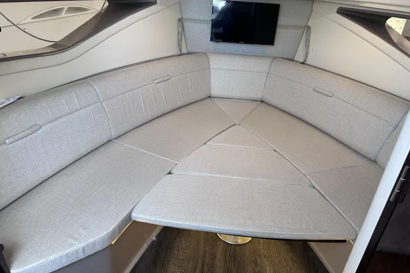 Slide: The Image of 2020 Sea Ray Sundancer 320 Coupe interior with cozy seating and mounted TV. - 23