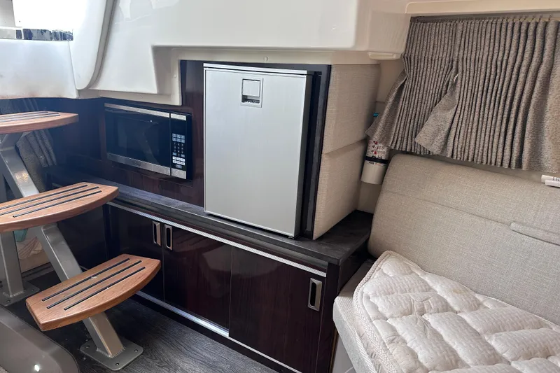 Slide: The Image of Interior of 2020 Sea Ray Sundancer 320 Coupe with kitchenette and seating area. - 24