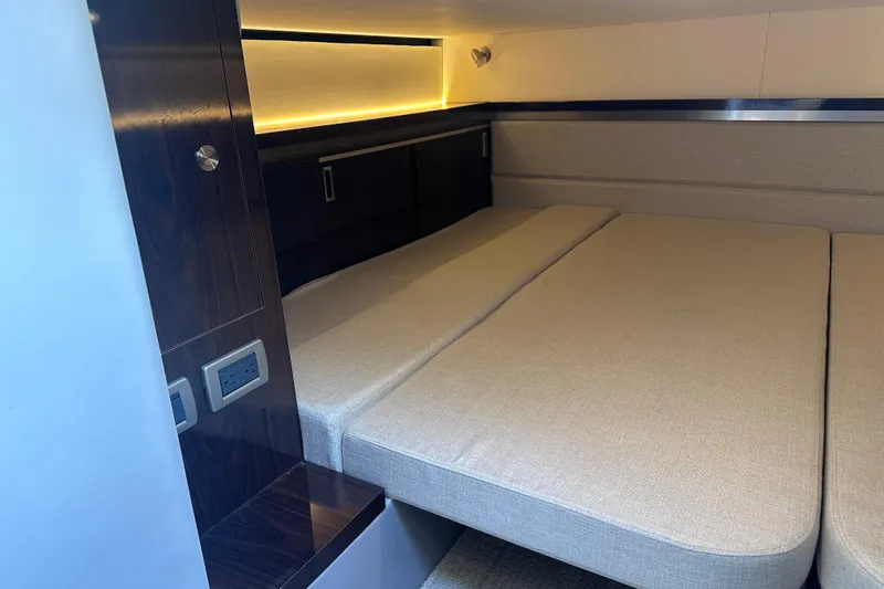 Slide: The Image of Interior cabin of 2020 Sea Ray Sundancer 320 Coupe with beige bedding. - 26