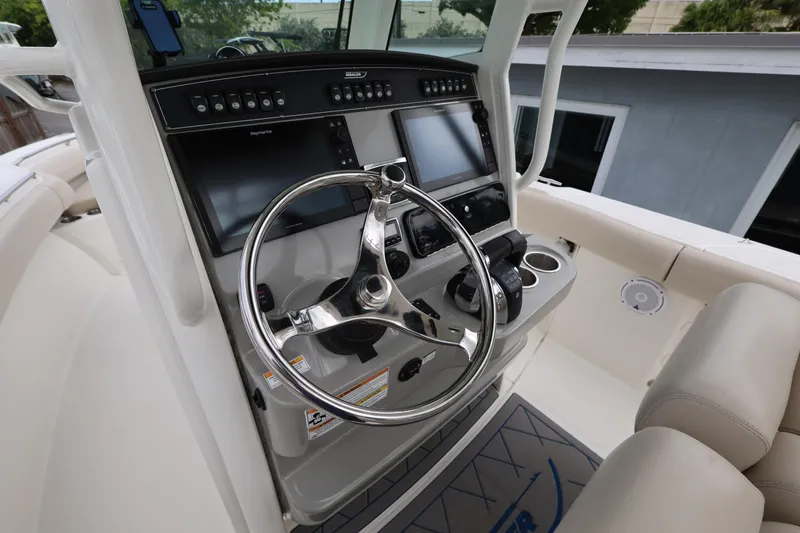 Slide: The Image of Steering console of a 2016 Boston Whaler 250 Outrage boat with modern controls. - 10