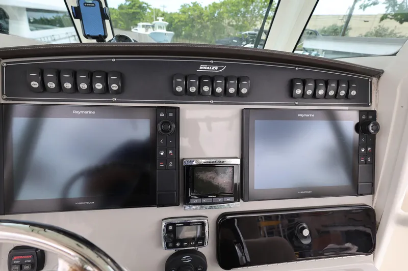 Slide: The Image of Dashboard of a 2016 Boston Whaler 250 Outrage with Raymarine displays and controls. - 12