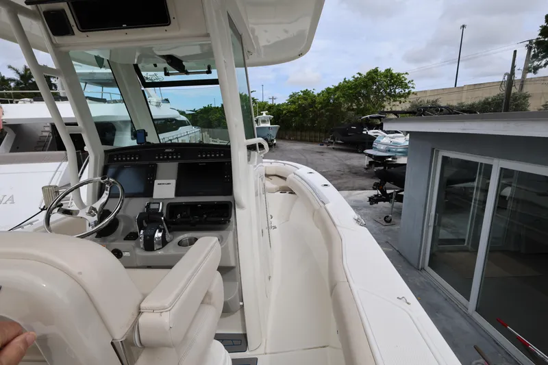 Slide: The Image of 2016 Boston Whaler 250 Outrage boat interior with steering console and seating. - 14