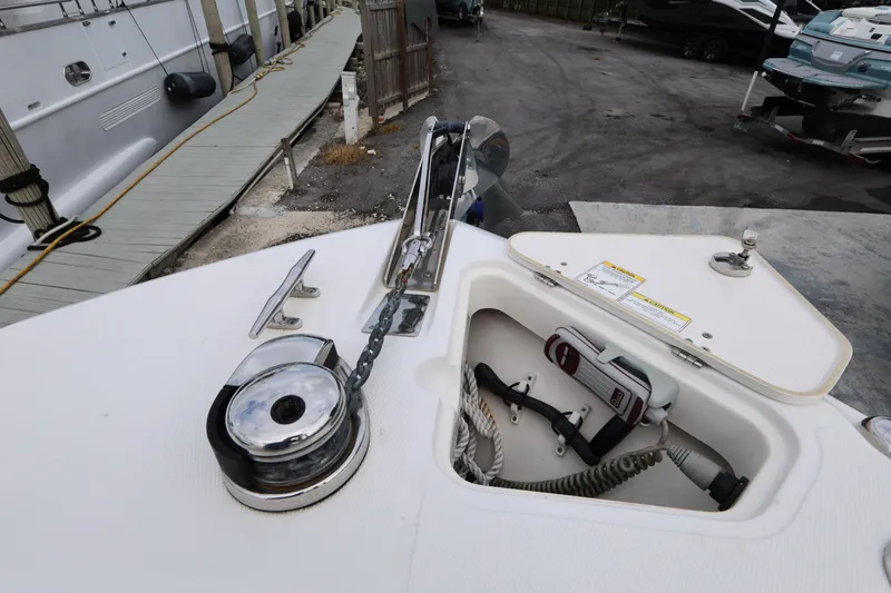 Slide: The Image of 2016 Boston Whaler 250 Outrage anchor compartment with chain and storage. - 17