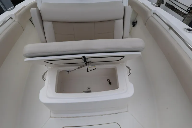 Slide: The Image of 2016 Boston Whaler 250 Outrage boat seat with storage compartment open. - 19