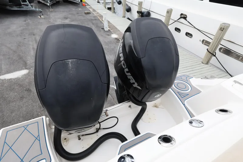 Slide: The Image of Twin Mercury outboard engines on a 2016 Boston Whaler 250 Outrage boat at dock. - 23