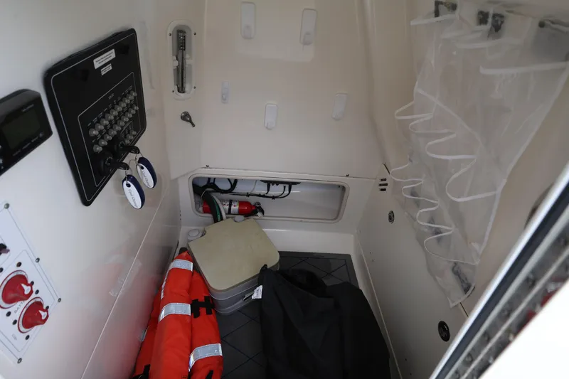 Slide: The Image of Interior of a 2016 Boston Whaler 250 Outrage boat with safety equipment. - 24