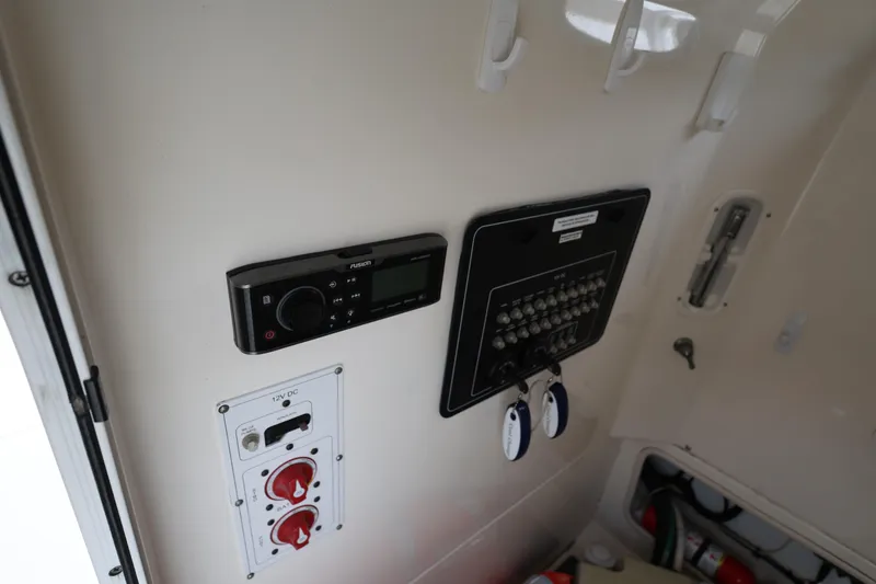 Slide: The Image of Control panel of a 2016 Boston Whaler 250 Outrage boat interior. - 25