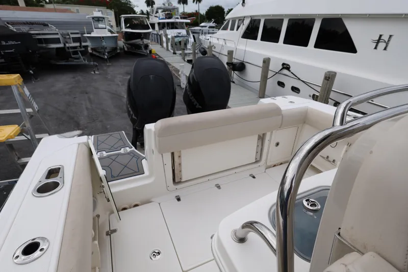 Slide: The Image of 2016 Boston Whaler 250 Outrage boat interior with dual engines at a marina. - 26