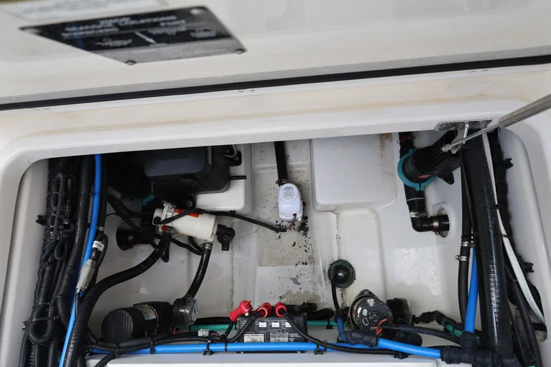 Slide: The Image of 2016 Boston Whaler 250 Outrage engine compartment with wiring and components visible. - 28