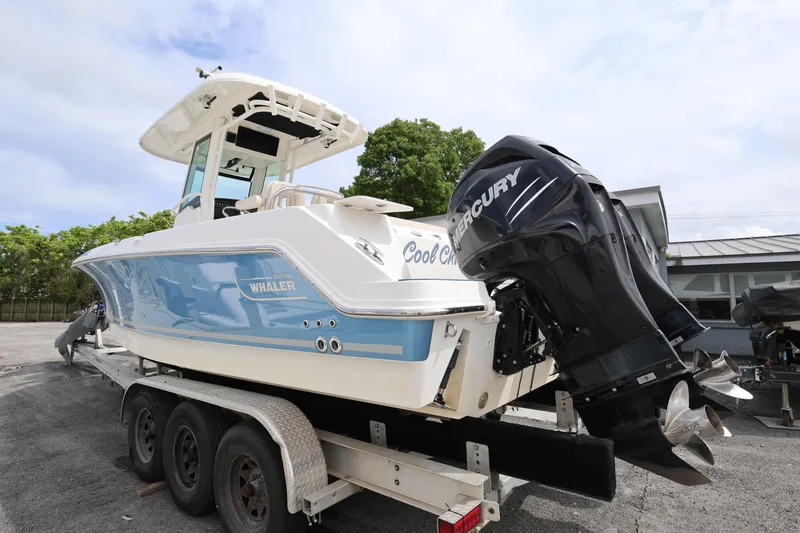 Slide: The Image of 2016 Boston Whaler 250 Outrage boat on trailer with Mercury outboard engine. - 5