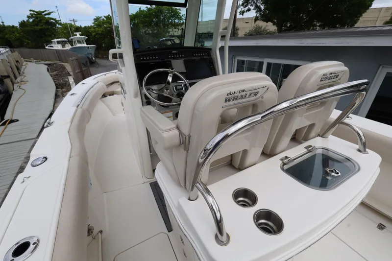 Slide: The Image of 2016 Boston Whaler 250 Outrage boat interior with helm and seating area. - 8
