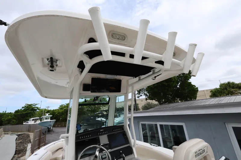 Slide: The Image of 2016 Boston Whaler 250 Outrage boat console with rod holders and electronics. - 9