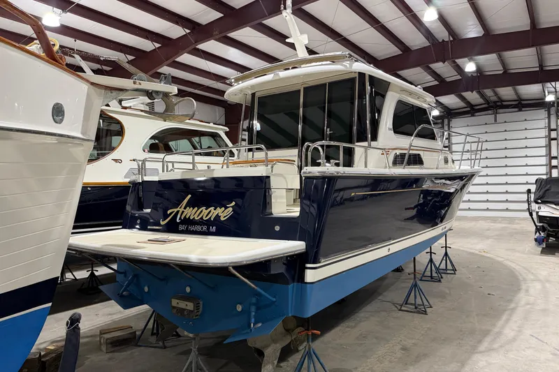 Slide: The Image of 2017 Sabre 38 Salon Express yacht in storage, featuring sleek design and blue hull. - 15