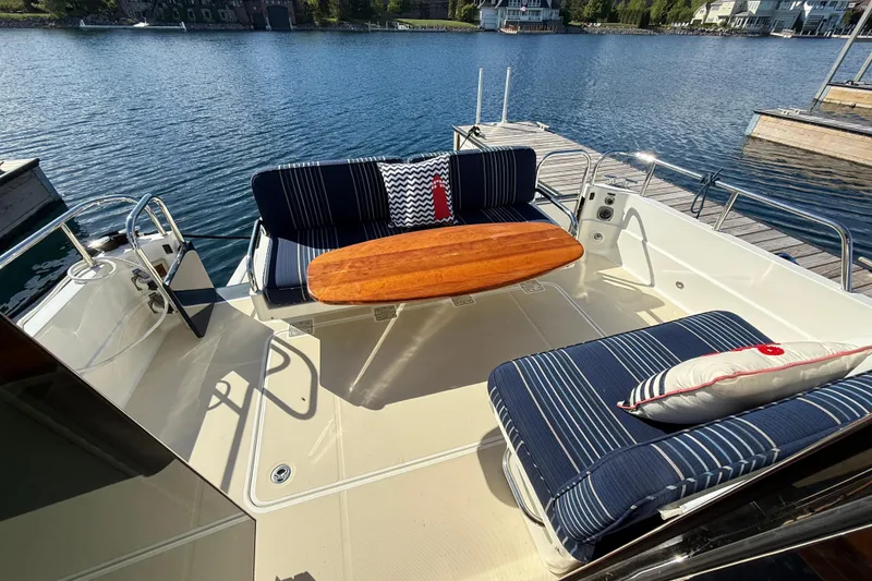 Slide: The Image of 2017 Sabre 38 Salon Express yacht with elegant outdoor seating and wooden table. - 22