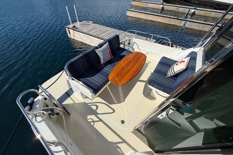 Slide: The Image of 2017 Sabre 38 Salon Express yacht deck with seating and table by the water. - 24