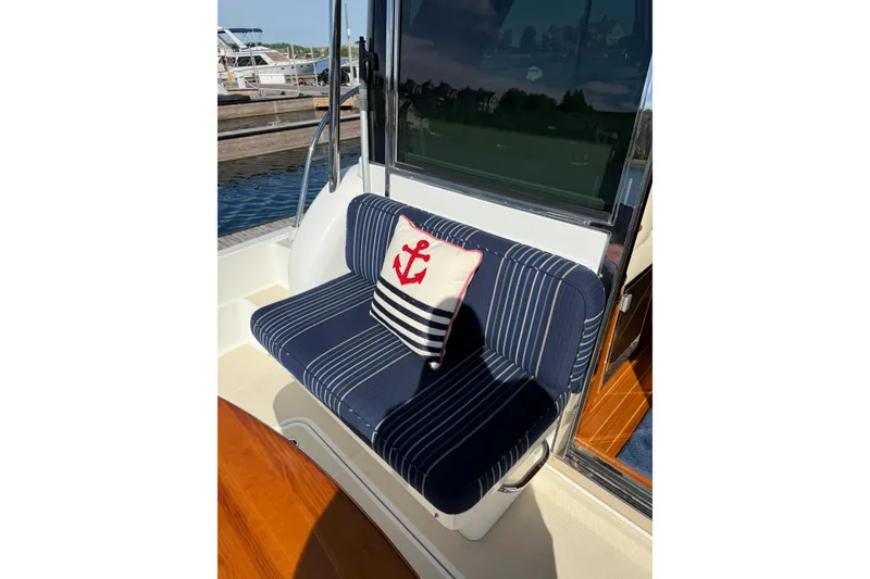 Slide: The Image of Nautical-themed seating on 2017 Sabre 38 Salon Express yacht with anchor pillow. - 25