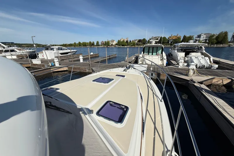 Slide: The Image of 2017 Sabre 38 Salon Express yacht docked at a marina under clear blue skies. - 26