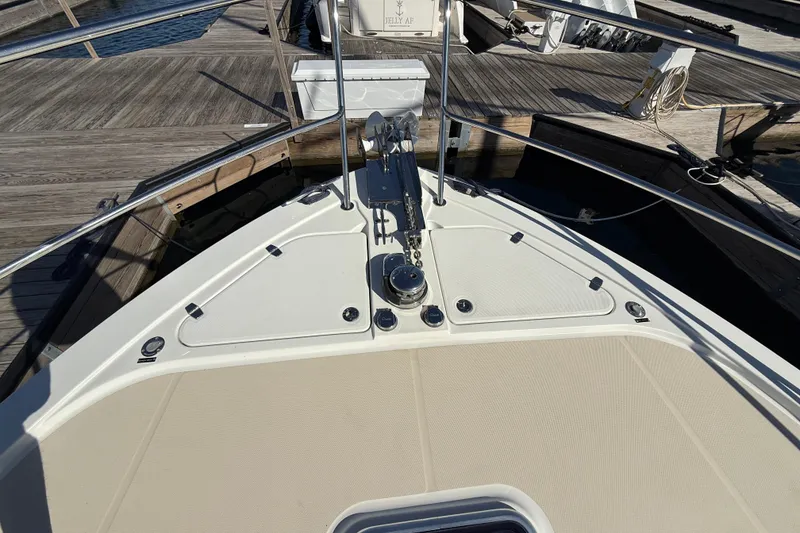 Slide: The Image of Bow of 2017 Sabre 38 Salon Express yacht docked at marina. - 27