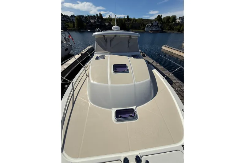Slide: The Image of 2017 Sabre 38 Salon Express yacht docked, showcasing sleek deck design and waterfront view. - 28