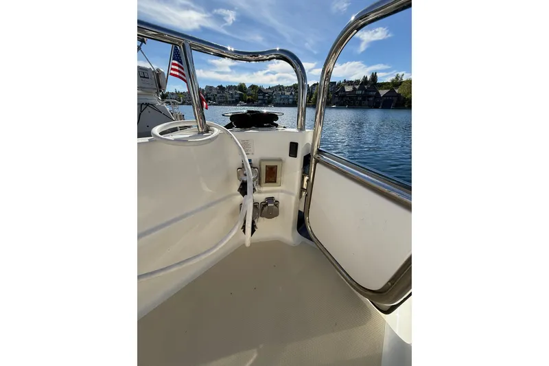 Slide: The Image of 2017 Sabre 38 Salon Express boat deck with railing, overlooking serene waterfront homes. - 32