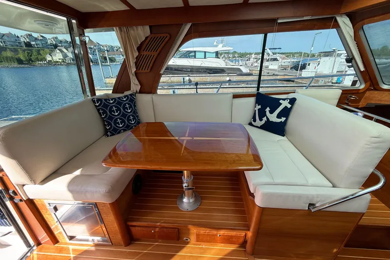 Slide: The Image of Interior of 2017 Sabre 38 Salon Express with elegant seating and nautical-themed cushions. - 39