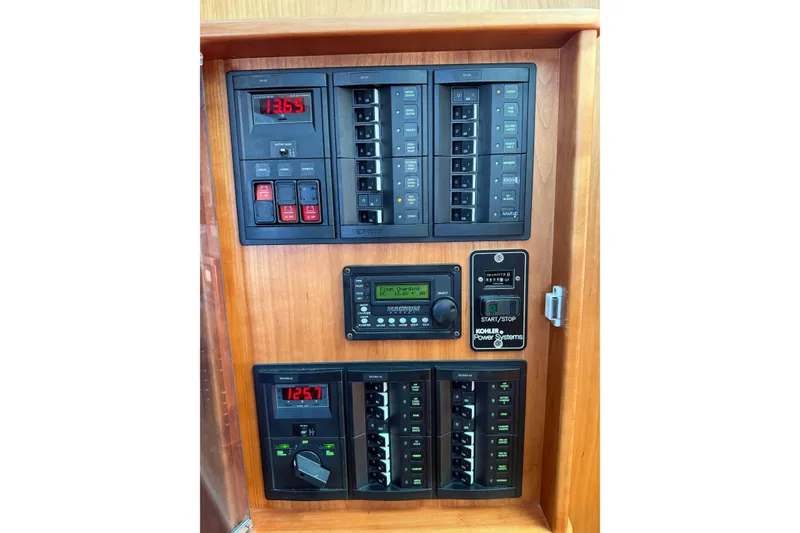 Slide: The Image of Electrical control panel on 2017 Sabre 38 Salon Express yacht, featuring various switches and displays. - 48