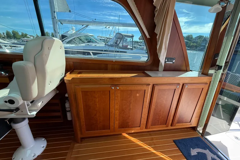 Slide: The Image of Interior of 2017 Sabre 38 Salon Express yacht with wooden cabinetry and white captain's chair. - 50