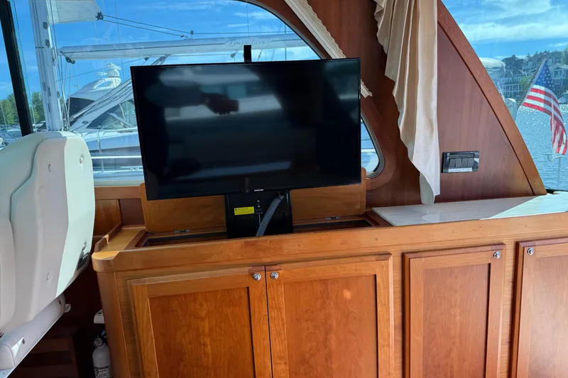 Slide: The Image of Interior of 2017 Sabre 38 Salon Express with TV and wooden cabinetry. - 51
