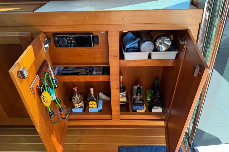 Slide: The Image of Wooden cabinet on 2017 Sabre 38 Salon Express, stocked with liquor bottles and accessories. - 52