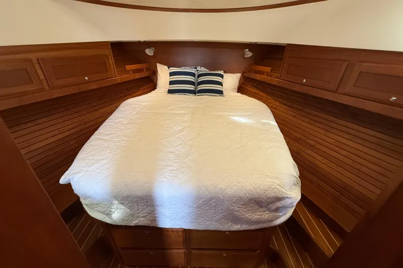 Slide: The Image of Cozy cabin interior of 2017 Sabre 38 Salon Express with wooden paneling and comfortable bedding. - 53
