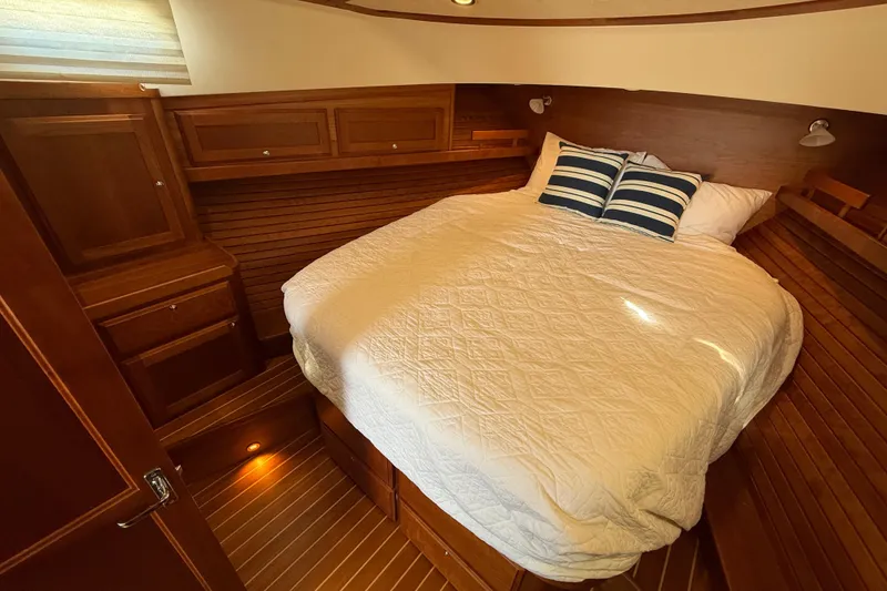 Slide: The Image of Cozy cabin bedroom in 2017 Sabre 38 Salon Express yacht with wood paneling. - 54