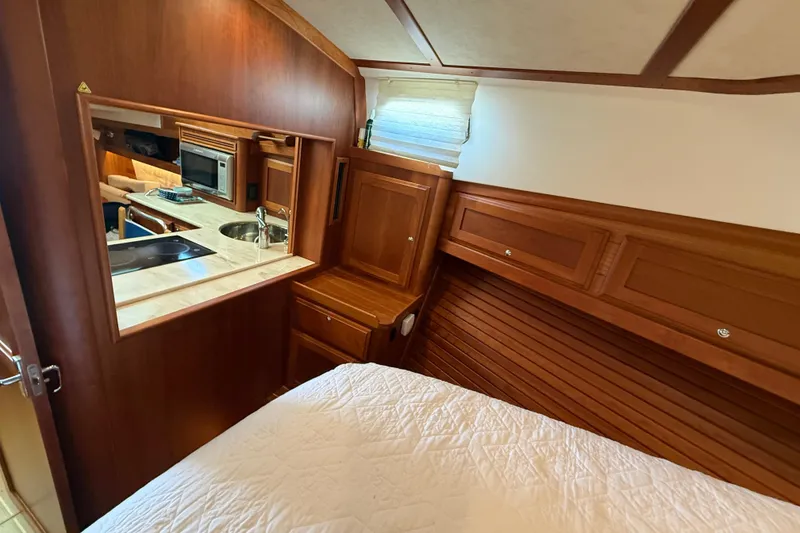 Slide: The Image of 2017 Sabre 38 Salon Express interior with wood finish, kitchenette, and cozy sleeping area. - 57