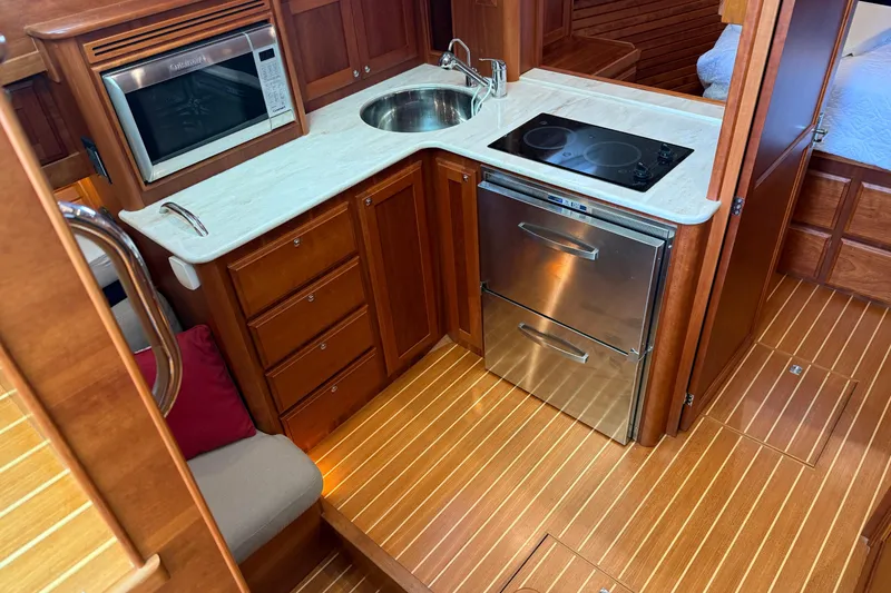 Slide: The Image of Luxurious 2017 Sabre 38 Salon Express yacht kitchen with wood cabinetry and modern appliances. - 63