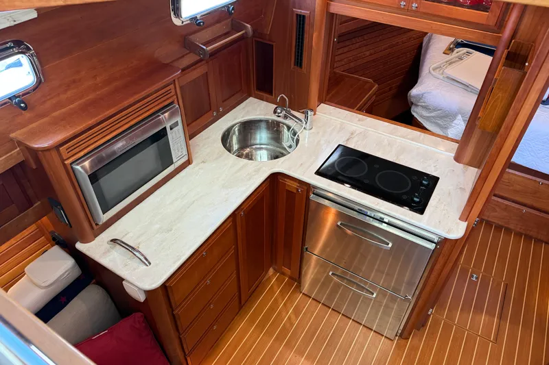 Slide: The Image of Luxurious 2017 Sabre 38 Salon Express galley with modern appliances and elegant wood finish. - 64