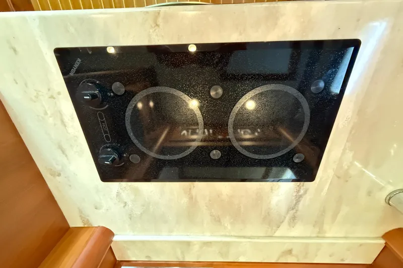 Slide: The Image of Stovetop on 2017 Sabre 38 Salon Express yacht, featuring sleek black glass design. - 66