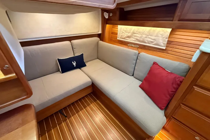 Slide: The Image of 2017 Sabre 38 Salon Express interior with cozy L-shaped seating and decorative cushions. - 68