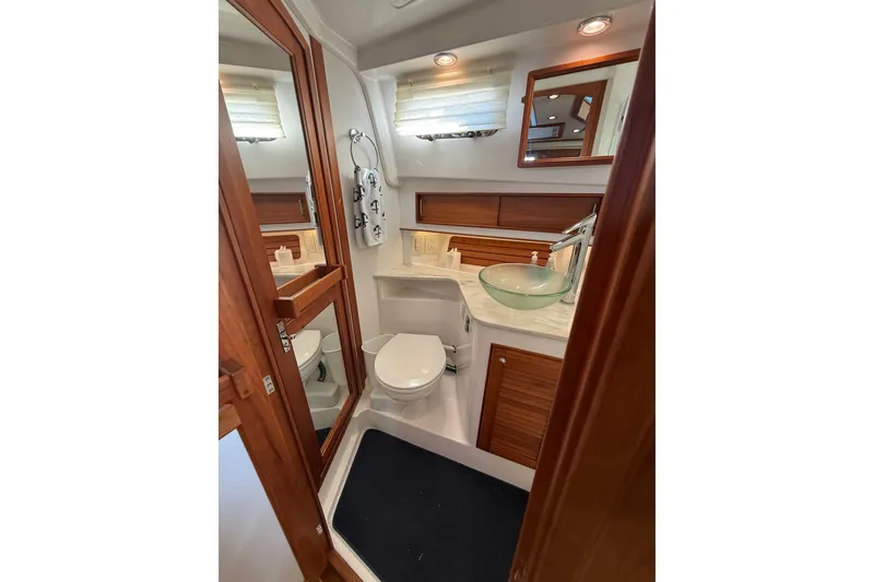 Slide: The Image of Luxurious bathroom in 2017 Sabre 38 Salon Express yacht with modern fixtures and wood accents. - 71